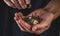 Men`s hands hold ruble coins close-up on a dark background. Concept of poverty and misery