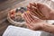 Men`s hands of prayer with wooden beads in sunlight, iftar concept, Ramadan month