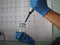 Men`s hands scientists are using aquatic release micropipette into the test tube. The process of research and development in