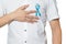 Men`s healthcare concept - male hand pointing to light blue ribbon for prostate cancer at left chest isolated on white background