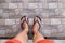 Men`s legs in black flip flops and red shorts go down and walk down the stairs. Walking style