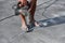 Men`s legs in flip-flops are very dusty and dirty because of the fact that a man works with a puncher, drills a concrete