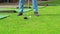 men\'s legs. a man hits a golf club on a ball.