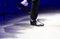 Men\'s legs in motion in stage trousers with stripes and leather shoes for Irish dancing on the floor