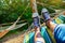 Men`s legs in sneakers in a hammock. Close-up. Summer concept, outdoor recreation