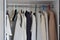 men\\\'s light clothes hang on hangers in the closet