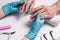 Men`s manicure. Cosmetologist in rubber gloves examines the condition of the nails.