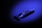 Men`s razor with an additional blade in a black and blue gradient background, shallow depth of field. Concept