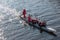 Men\'s rowing team on the blue water. Winter training