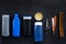 Men`s set for everyday body, facial and hair care. Shampoo, gel, tools for brushing, sciccors, comb on black background