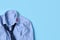 Men`s shirt with kiss mark and necktie on light blue background, top view. Space for text