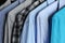 Men`s shirts on hangers, blue, gray and checkered