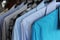 Men`s shirts on hangers, blue, gray and checkered