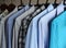 Men`s shirts on hangers, blue, gray and checkered