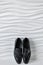 Men`s shoes on the background of wavy tiles on groom room.