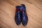 Men`s shoes and belt dark blue, wedding accessories, morning groom on a brown wooden background