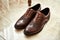 Men`s shoes lie on the floor. Different accessories of businessman for creating style of  people on  wooden background