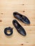 Men\\\'s shoes and a trouser belt made of dark blue leather on a wooden background, top view