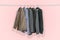 Men`s suits and jackets hung on clothes hangers isolated