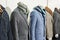 Men`s tweed sport coats with scarves in clothing store