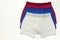 Men`s underwear, set of multi-colored underpants on white background flat lay top view copy space. Fashion blog, natural underwea