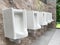 Men`s white urinals design, Close up row of outdoor urinals men public toilet