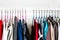 Men\\\'s and women\\\'s clothing on silicone hangers in the wardrobe closet. The same shoulders. Storage organization. Order and