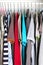 Men\\\'s and women\\\'s clothing on silicone hangers in the wardrobe closet. The same shoulders. Storage organization. Order and