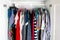 Men\\\'s and women\\\'s clothing on silicone hangers in the wardrobe closet. The same shoulders. Storage organization. Order and