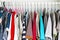 Men\\\'s and women\\\'s clothing on silicone hangers in the wardrobe closet. The same shoulders. Storage organization. Order and