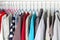 Men\\\'s and women\\\'s clothing on silicone hangers in the wardrobe closet. The same shoulders. Storage organization. Order and