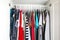 Men\\\'s and women\\\'s clothing on silicone hangers in the wardrobe closet. The same shoulders. Storage organization. Order and