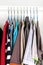 Men\\\'s and women\\\'s clothing on silicone hangers in the wardrobe closet. The same shoulders. Storage organization. Order and