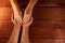 Men`s and women`s hands. Wife put her hands on her husband`s palms on background of a red textured wooden table. Concept of family