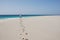 Men on sandy beach - blue ocean and sky