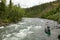 Men setting off on canoe rapid adventure in Alaska