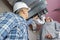 men setting up ventilation system indoors