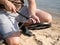 Men on the shore getting ready for a treasure hunt with a metal detector