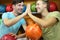 Men sit near shelves with balls in bowling club