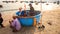 Men Sit in Stand at Round Fishing Boat on Beach in Vietnam