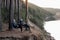 Men sitting in folding chairs on cliff by river