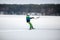 Men ski kiting on a frozen lake