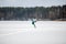 Men ski kiting on a frozen lake