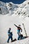 men skiers putting on climbing harness. Hiking equipment, mountaineering equipment.