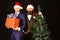 Men in smart suits and Santa hats on brown background