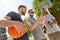 Men with smartphone on basketball playground