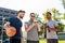 Men with smartphone at basketball playground