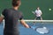 Men sport athletes players playing tennis match together. Two professional tennis players hitting ball on hard outdoor