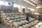 Men stacking large bags of coffee beans in a warehouse