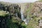 Men stand on edge of cliff at river gorge